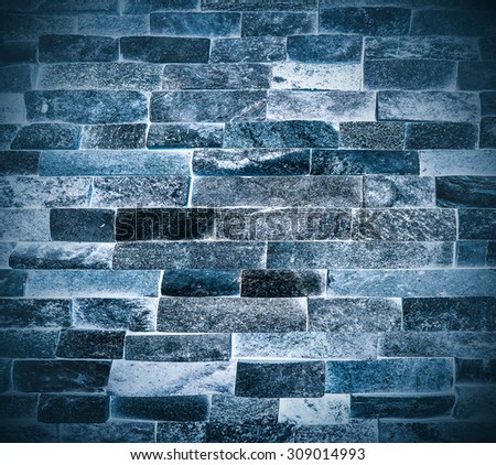 Abstract weathered texture of stained old dark stucco snowy and painted blue, black brick wall background in rural room Grungy frosty blocks of ice stonework glacial retro color architecture wallpaper