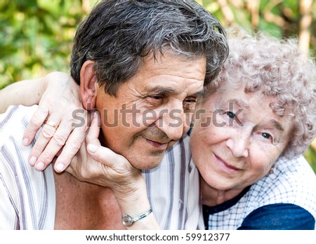 elderly people hugging