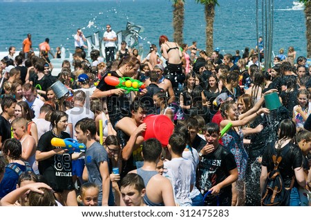 Odessa, Ukraine - July 1, 2015: young people shooting and throwing water at each other during a flash mob \