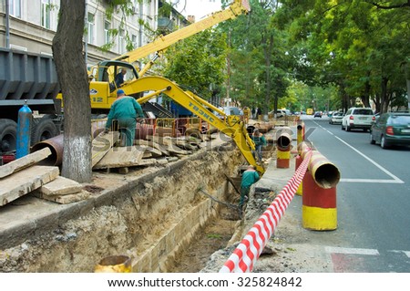 ODESSA, UKRAINE - 09 October 2015: Repair and replacement of outdated pipes in the city center. Welding pipeline segments.