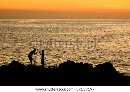 Sunset with two fishermen on Maui a Hawaiian island