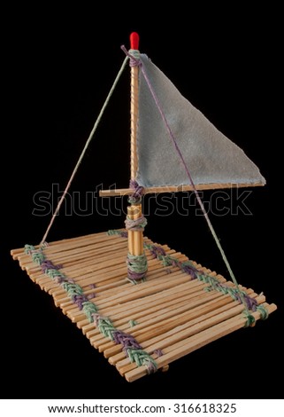 Wooden raft made of long matches, positioned at 45 degree angle to the camera lens and photographed on the black background