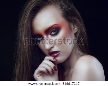 girl with fashion orange make-up on black background