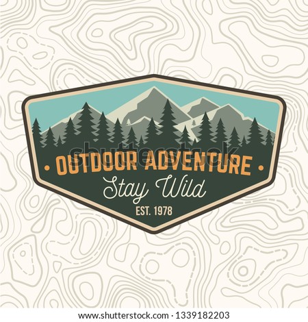 Stay wild, outdoor adventure patch. Vector illustration. Concept for shirt or print, stamp or tee. Vintage typography design with mountains and forest silhouette. Outdoor adventure badge.