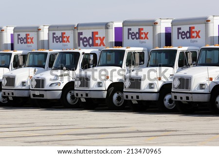 Chicago, Illinois, USA - April 6, 2014: A fleet of large FedEx delivery trucks parked at a Federal Express facility at the O\'Hare Airport in Chicago.
