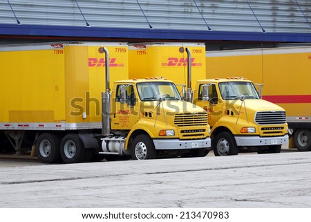 Chicago, Illinois, USA - May 3, 2014: DHL trucks and trailers parked at a cargo distribution hub at Chicago\'s O\'Hare International Airport. Chicago - May 3, 2014