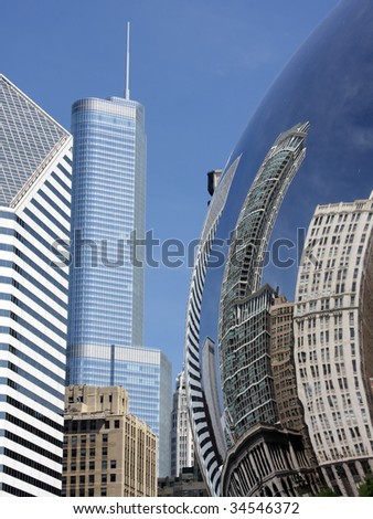 Buildings in Chicago reflected on silver sphere in the park