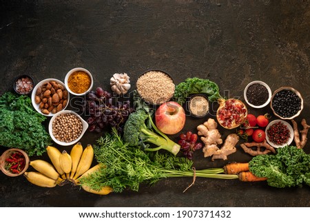 Healthy food clean eating selection: fish,fruit, vegetable, seeds, superfood, cereals, leaf vegetable on old kitchen table background copy space. Healthy food for humans. Background  with for text
