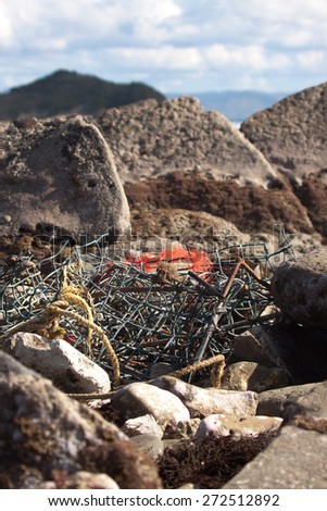 fishing net and gear caught in rocky foreshore, Gisborne, East Coast, New Zealand
