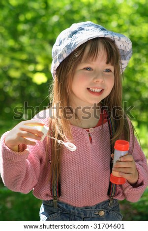 Little girl makes soap bubbles