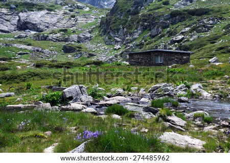 Extreme terrain, endemic flowers and lone house in the Rila mountains in Bulgaria