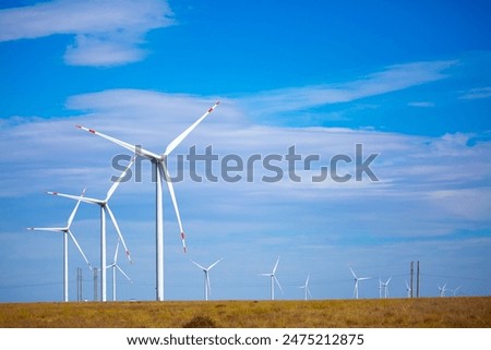 Similar – Image, Stock Photo Rotating windmill generating renewable energy wind power at land