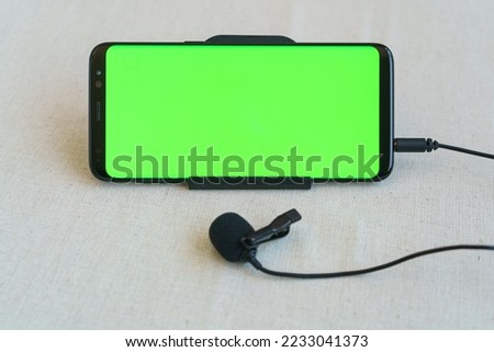 Mobile phone and microphone are on table