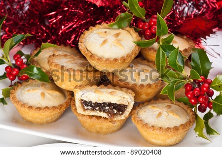 Christmas mince pies with holly and berries and christmas decorations