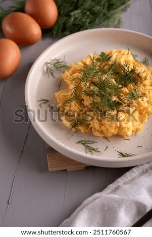 Similar – Image, Stock Photo Scrambled eggs in a blue plate, top view on a yellow table.