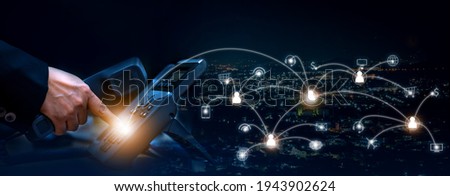 Concept of voip telecommunication, business woman pick up the handset and press the number button of ip telephone and connection line, services icon on night cityscape background