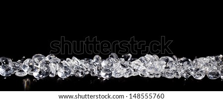 Pile of diamonds on a black background close up