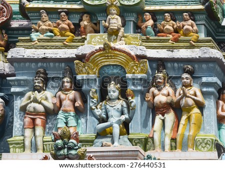 KUMBAKONAM, INDIA - OCTOBER 12, 2013: Mahalingeswarar Temple. Statue composition on Gopuram. Dhakshinamoorthy, Lord Shiva as supreme teacher. Here with the dwarf, Apasmara, under his foot.