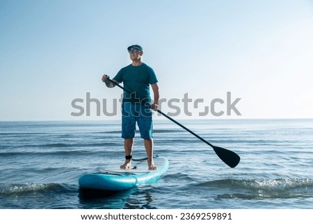 Similar – Image, Stock Photo Woman floating on paddleboard in lake