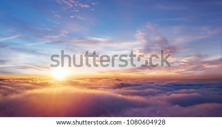 Beautiful sunset sky above clouds with dramatic light. Cabin view from airplane ストックフォト © 