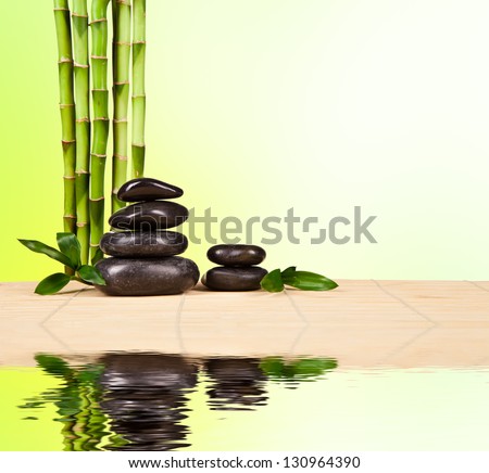 Spa still life with lava stones and bamboo sprouts with free space for text