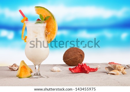 Summer drink on beach with sea shells