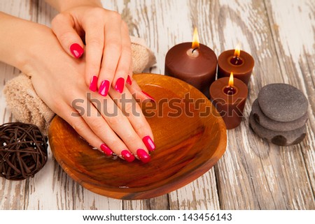 Soft woman hands with colored nails