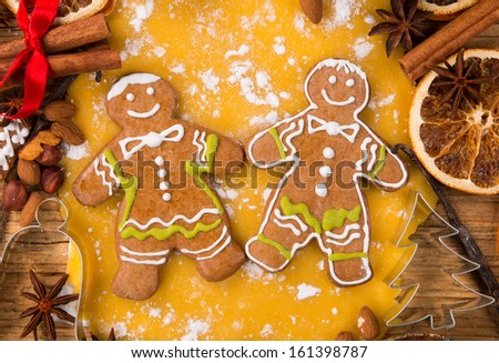 Gingerbread dought with cooked gingerbread and ingredients around