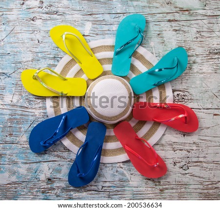 Concept of summer sandals and hat on wood, shot from upper view