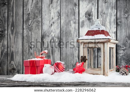 Christmas still life with lantern, gifts and balls. Wooden planks as background