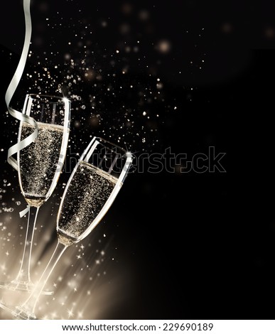 Two glasses of champagne with splash, on black background