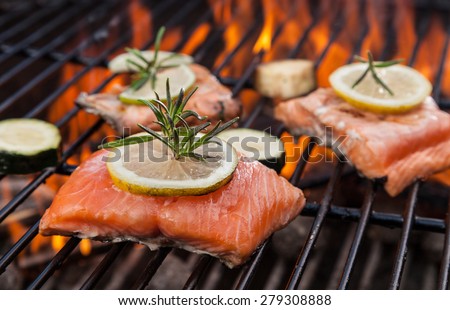 Delicious grilled salmon steaks on fire