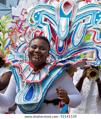 NASSAU, THE BAHAMAS - JANUARY 1 - Smiling, dancing group leader in brightly colored costume, performs in Junkanoo, a traditional island cultural festival in Nassau, The Bahamas on Jan 1, 2011.