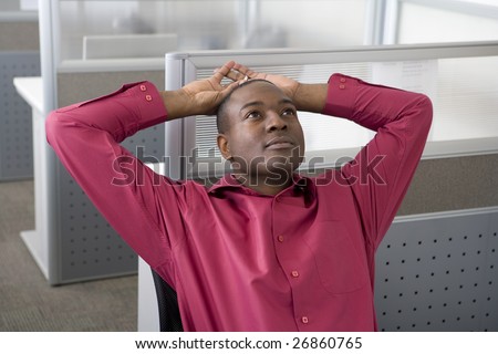 Businessman relaxing in office cubicle