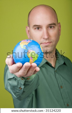 Man holding small globe