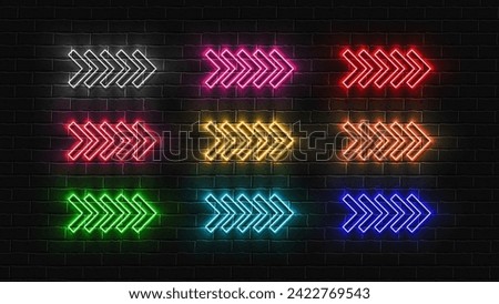 A set of bright shiny LED neon colored arrows on a brick wall background.