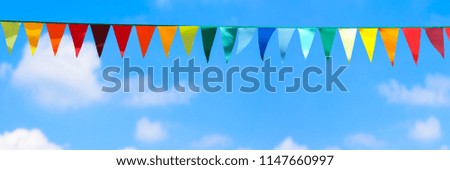 Similar – Image, Stock Photo A colourful pennant chain in pastel colours in front of a house wall