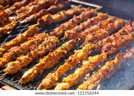 Barbecued sticks with chicken meat