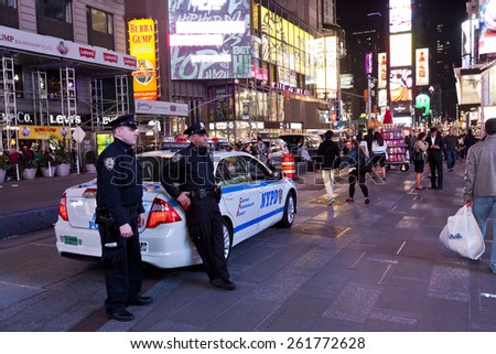 NEW YORK CITY, USA - OCT 9, 2014 : Police car and policemen in the Times Square. Times Square is major commercial intersection and one of most visited and protected tourist attractions in the world.