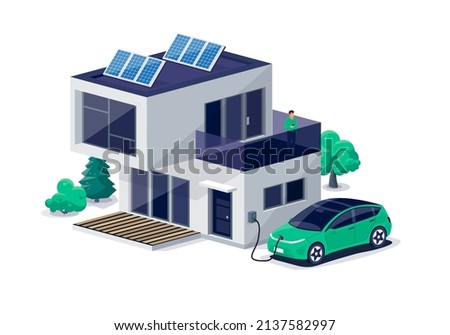 Electric car parking charging at home wall box charger station on modern residence family house. Energy storage with photovoltaic solar panels on building roof. Renewable power electricity backup grid