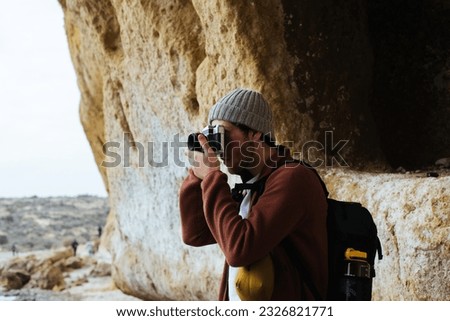 Man photographing landscape from observation deck