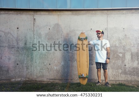 Similar – Image, Stock Photo Young bearded skater standing on ramp in skatepark