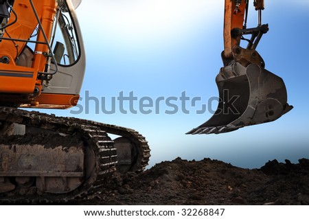a earth mover standing on the ground, behind is the sky