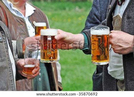 some people are standing together, drinking some alcohol