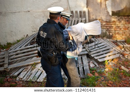 Police officers arresting a criminal