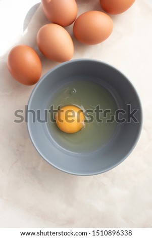 Similar – Image, Stock Photo Eggs in a bowl and baking ingredients on a kitchen table. Rustic.