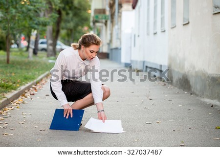 Business lawyer dropped on the street a folder with papers