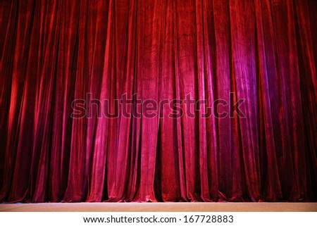 Closed crumpled red curtain over the scene