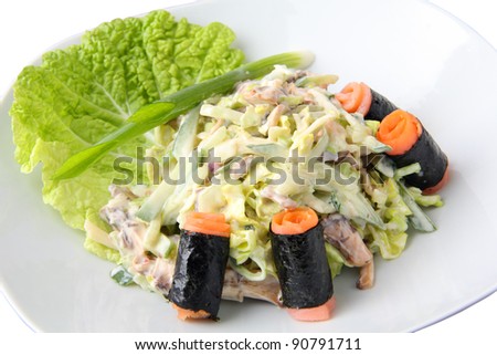 salad kunsey sarada with rolled slices of smoked salmon on a white dish isolated on a white dish