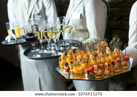 Canapes and wine on tray in waitor's hand Photo stock © 
